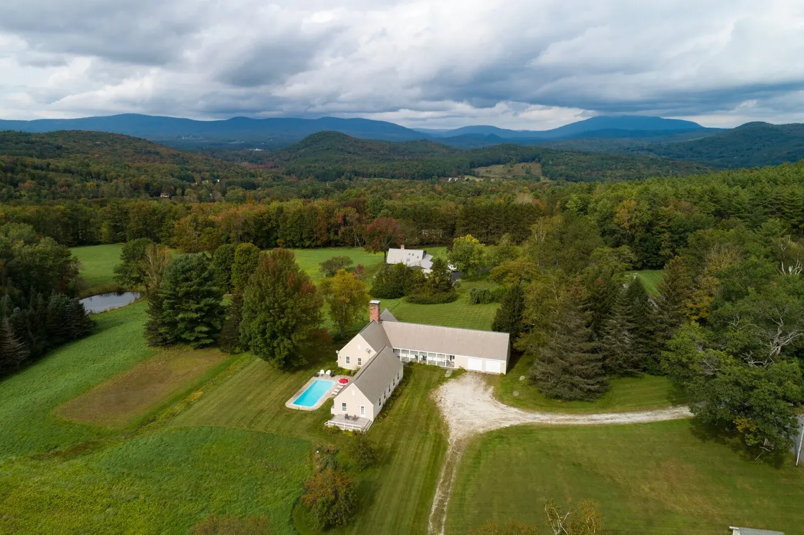 A Vermont house above a meadow, the Green Mountains beyond